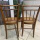 Pair of antique caned and wooden chairs from the 1900s.