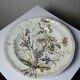 Antique Longchamp shallow dish with polychrome daisies in ironstone.