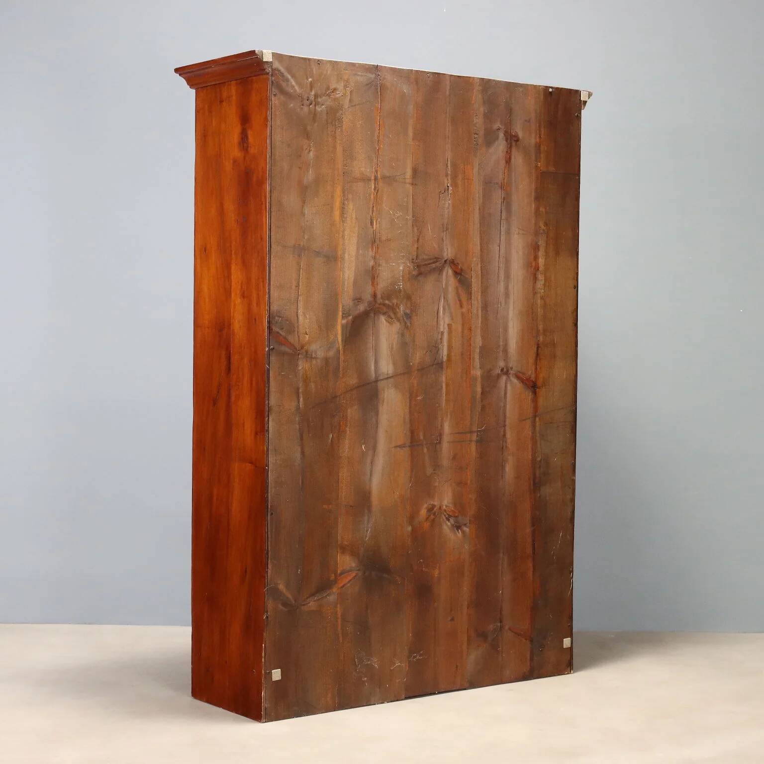 Vintage walnut wardrobe with exposed hardware.