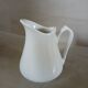 2 small white porcelain pitchers