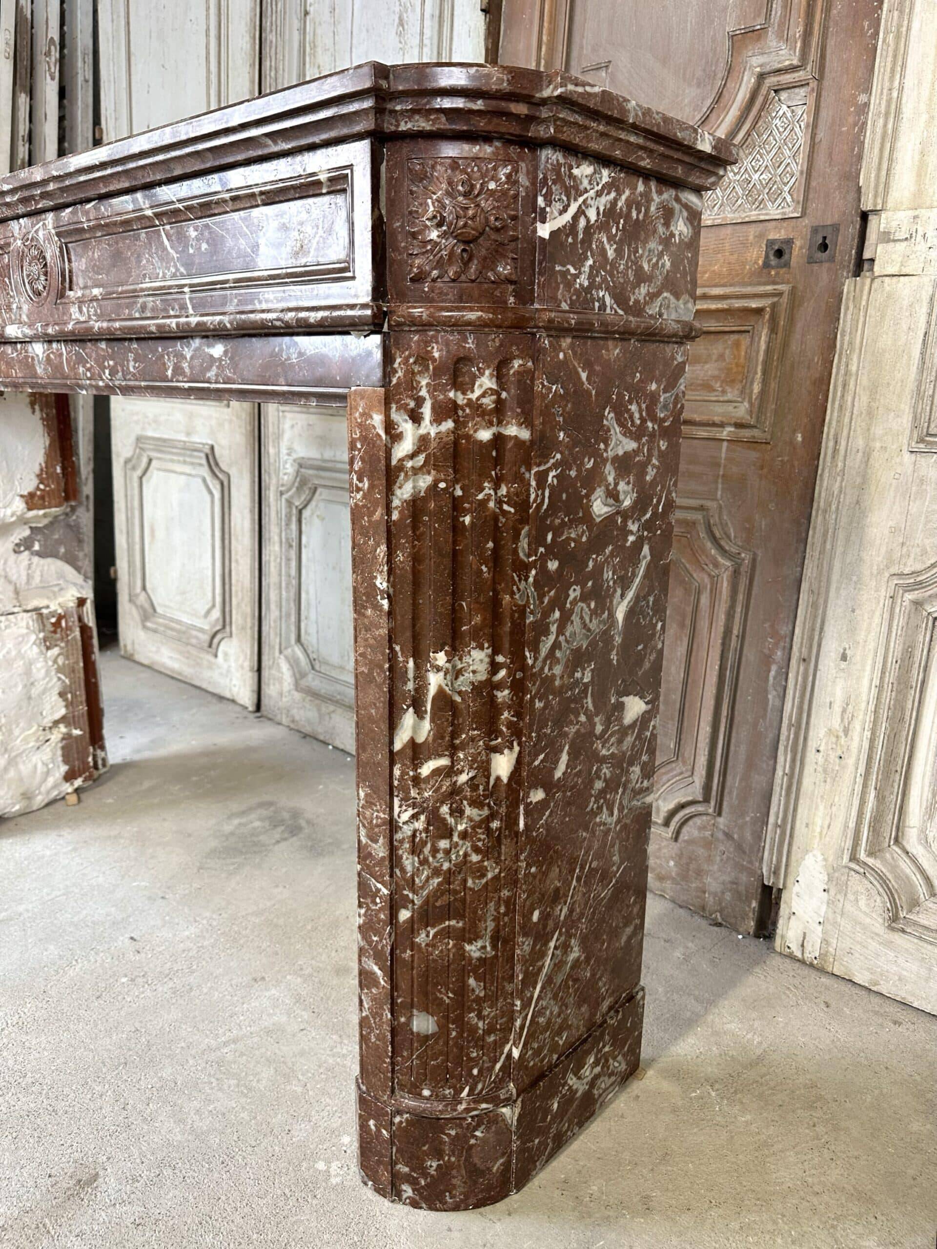 Red marble fireplace in the Louis XVI style, late 19th century