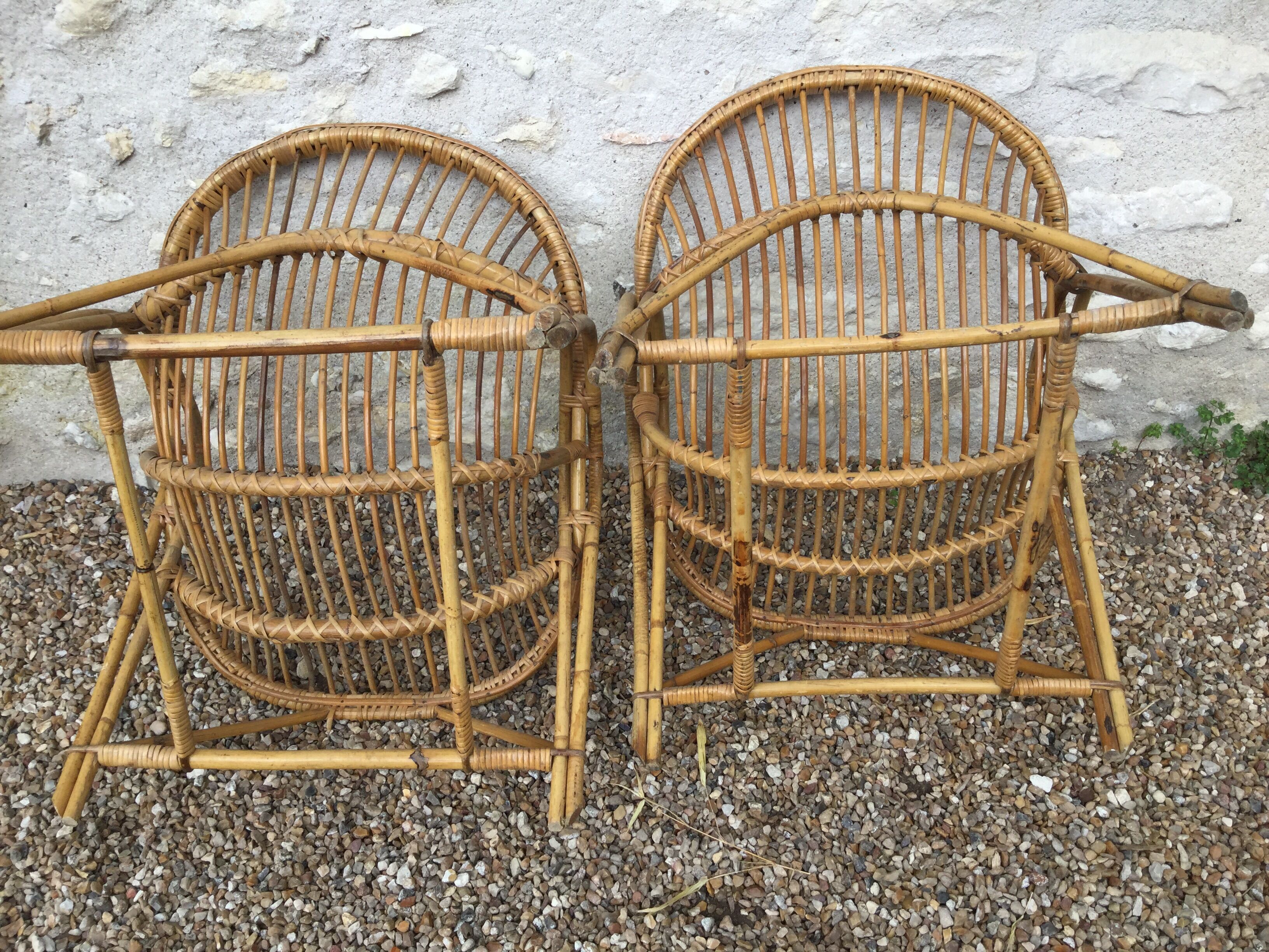 A pair of rattan armchairs
