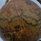 Cherub or putti carrying a globe