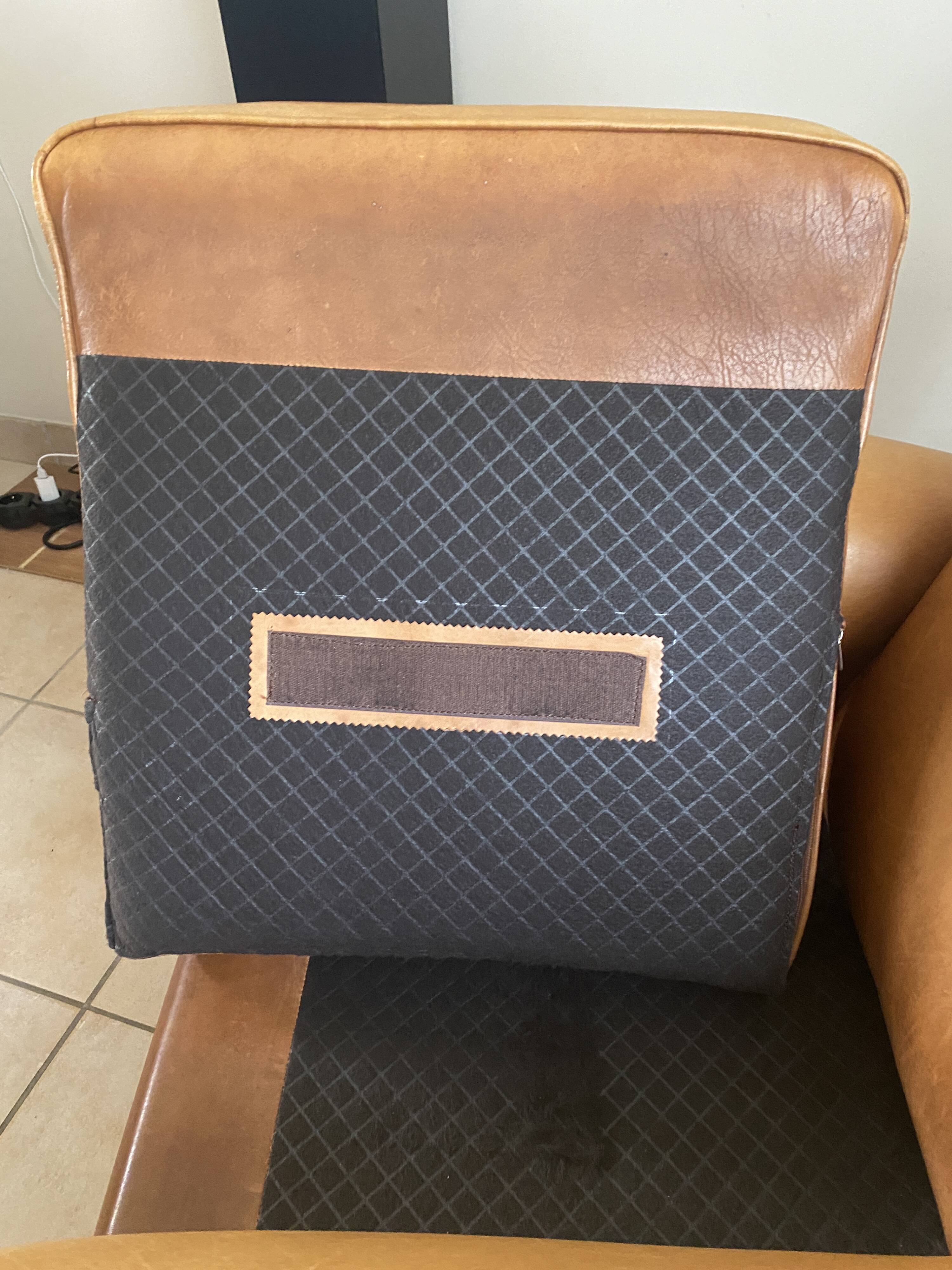 Brown leather club armchairs with an antique finish.