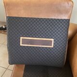 Brown leather club armchairs with an antique finish.