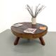 Brutalist coffee table in solid teak, monolithic slab, tripod base.