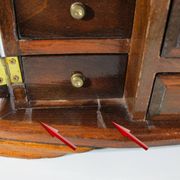 Wooden jewelry box in the shape of a dresser