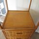 Storage column, wooden bookshelf and woven rattan.