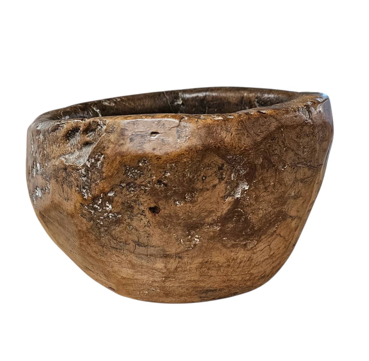 A substantial hand-hewn wooden bowl carved from a single burl section