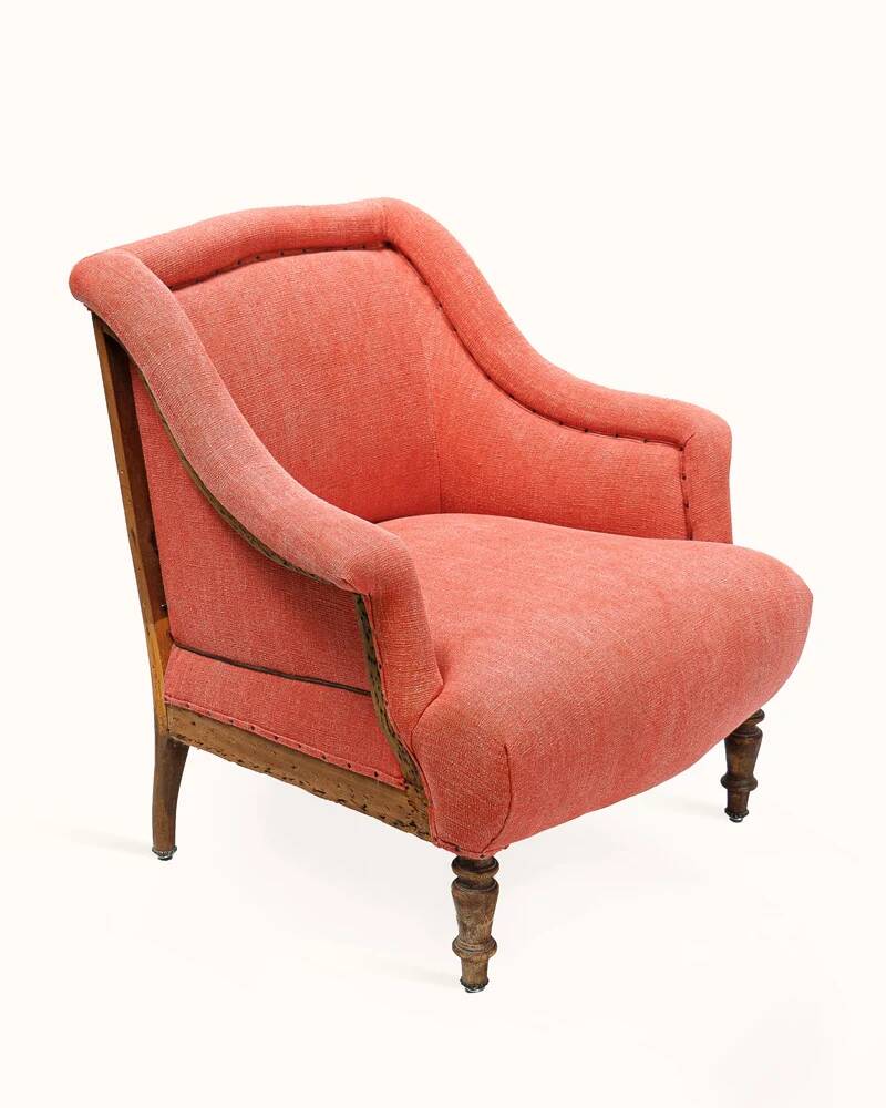Napoleon III salon armchair in brick red linen with a tufted footrest.