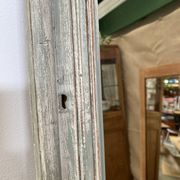 Antique mirror with a green and white patina.