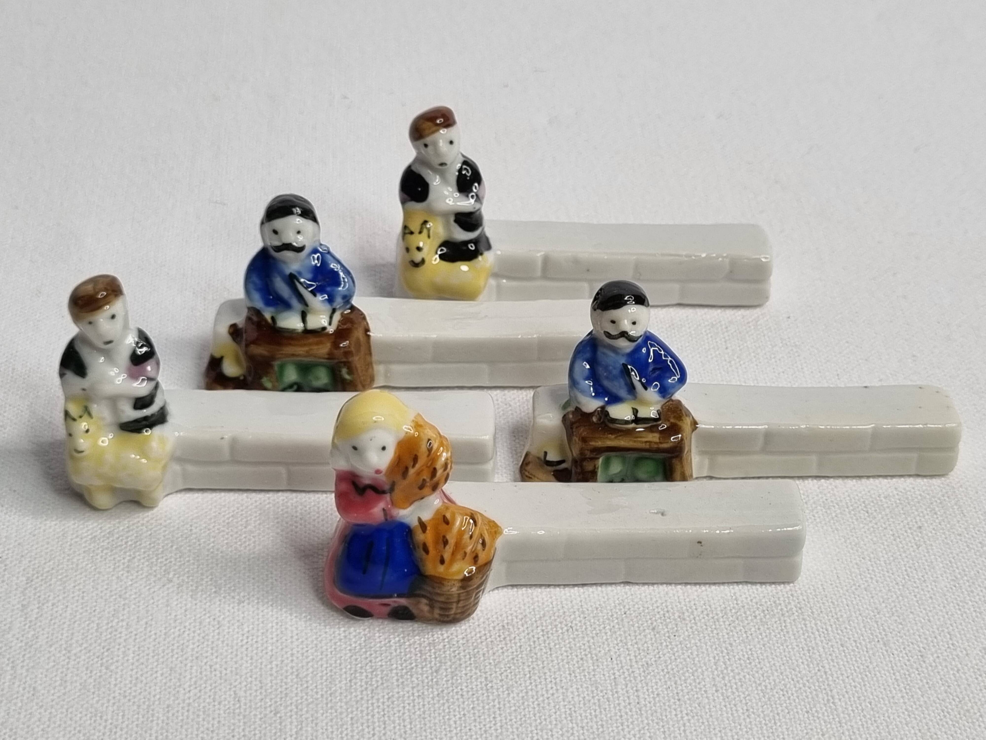 Five porcelain knife holders signed "Le Merzer", 6 cm