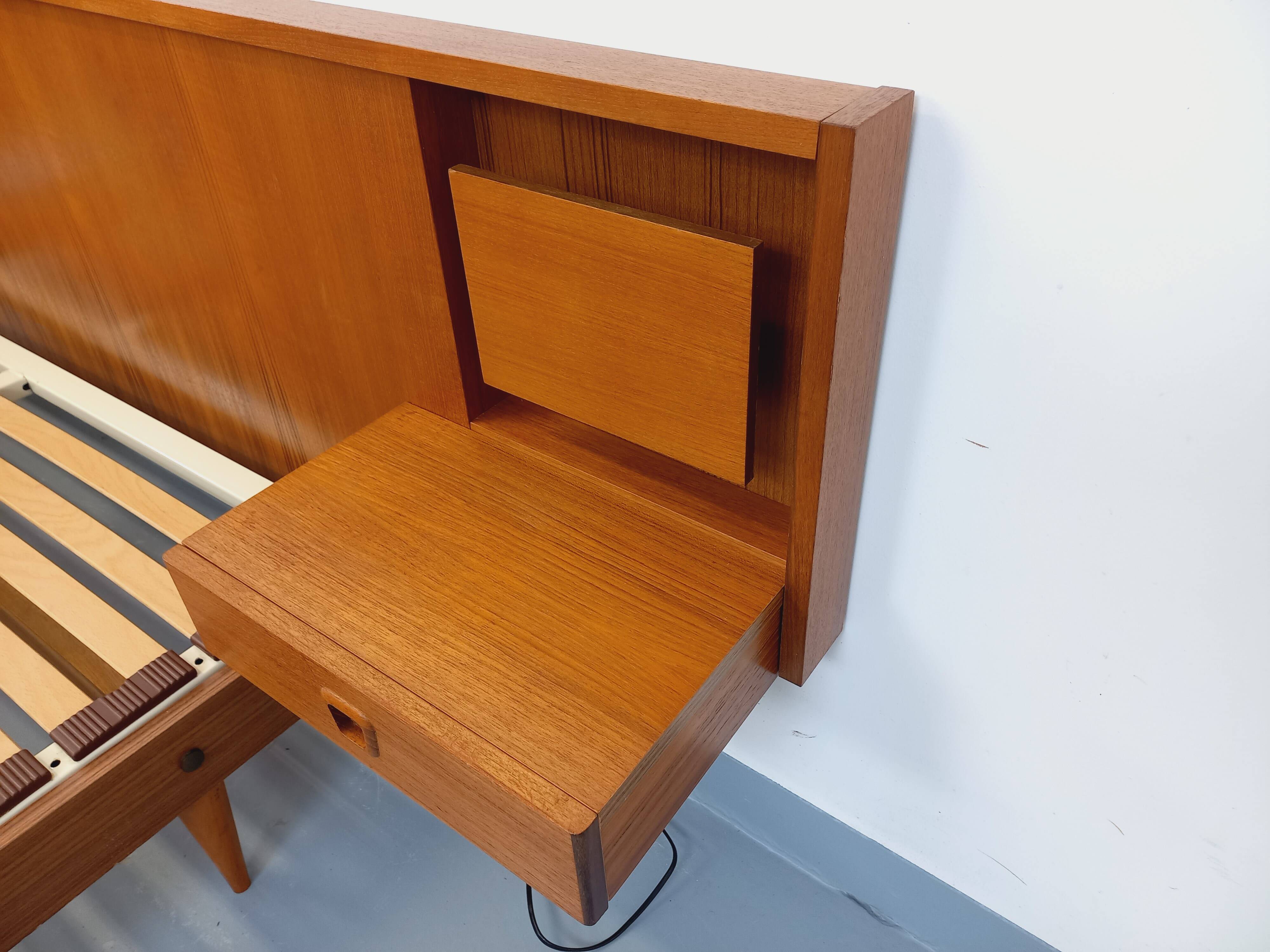 Double bed in vintage Scandinavian style from the 1960s with bedside tables in teak.