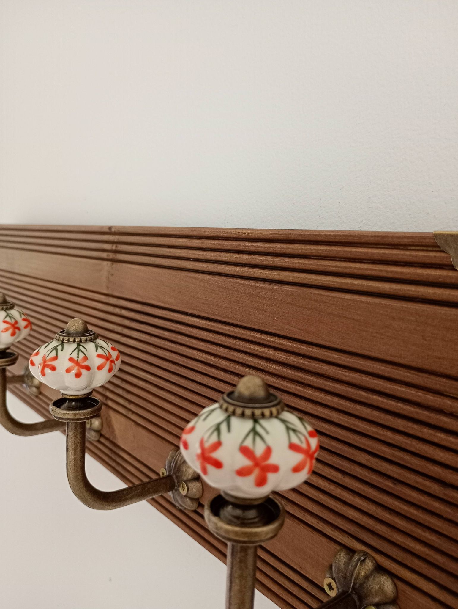 Vintage wall coat rack with 5 ceramic hooks featuring floral patterns - wood