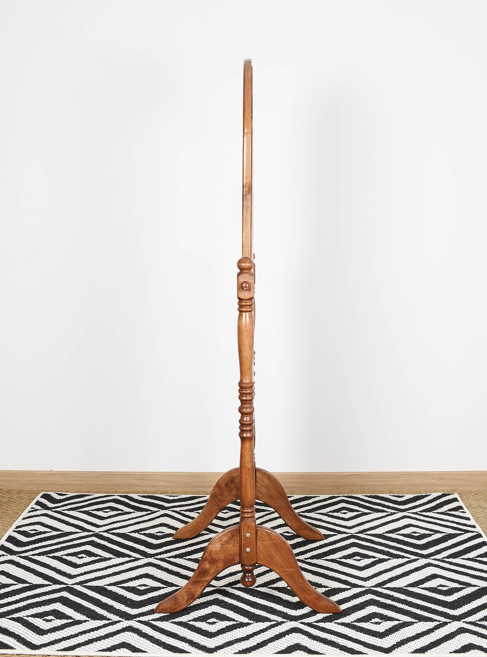 Large psychic mirror on legs with pivoting oval frame.