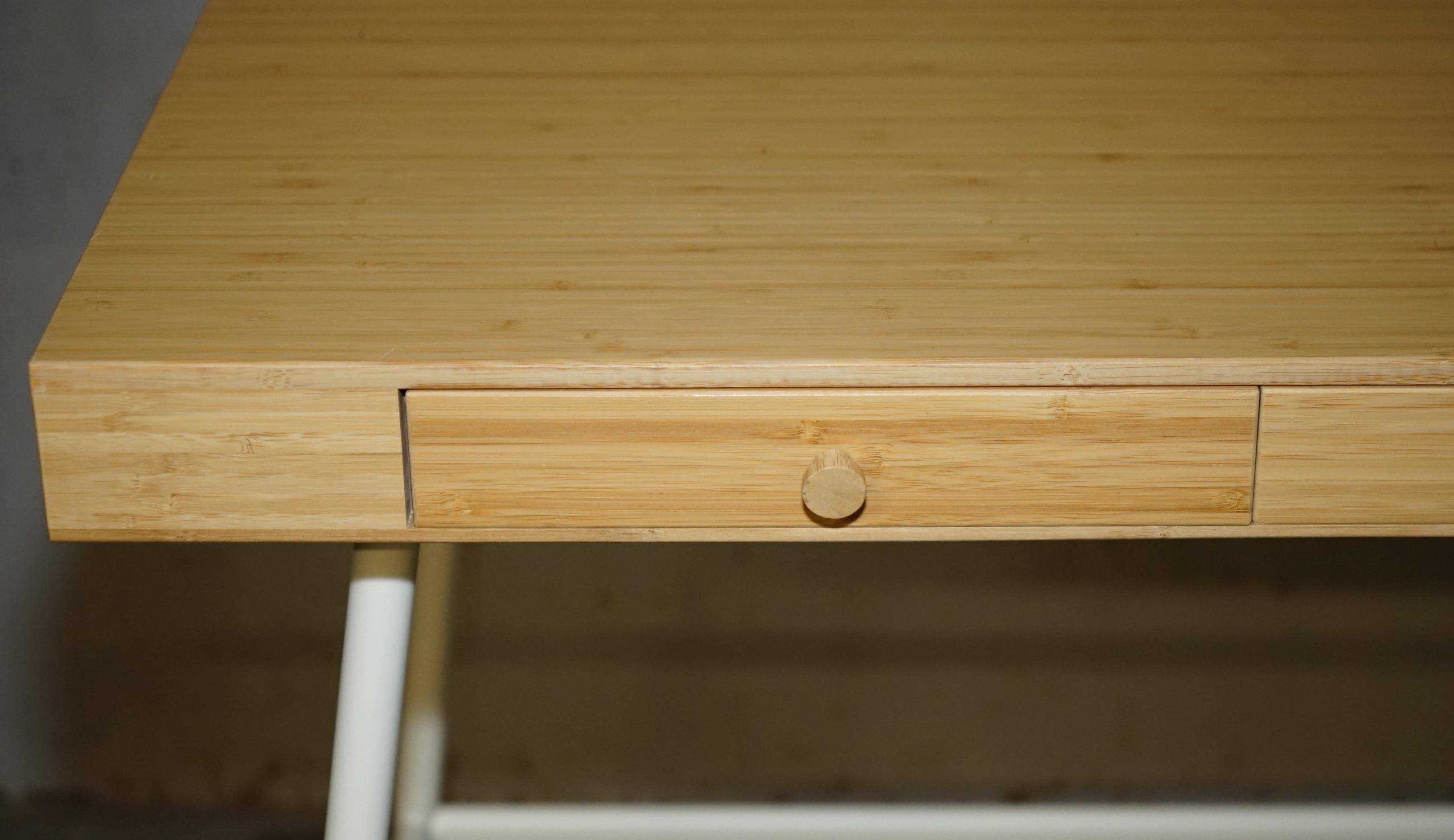 Small bamboo desk with three drawers.