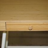 Small bamboo desk with three drawers.