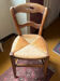 Old rustic wooden chair – carved backrest – seat in fibres