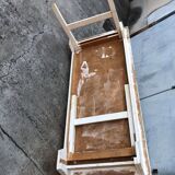 Old table in foldable wood painted white