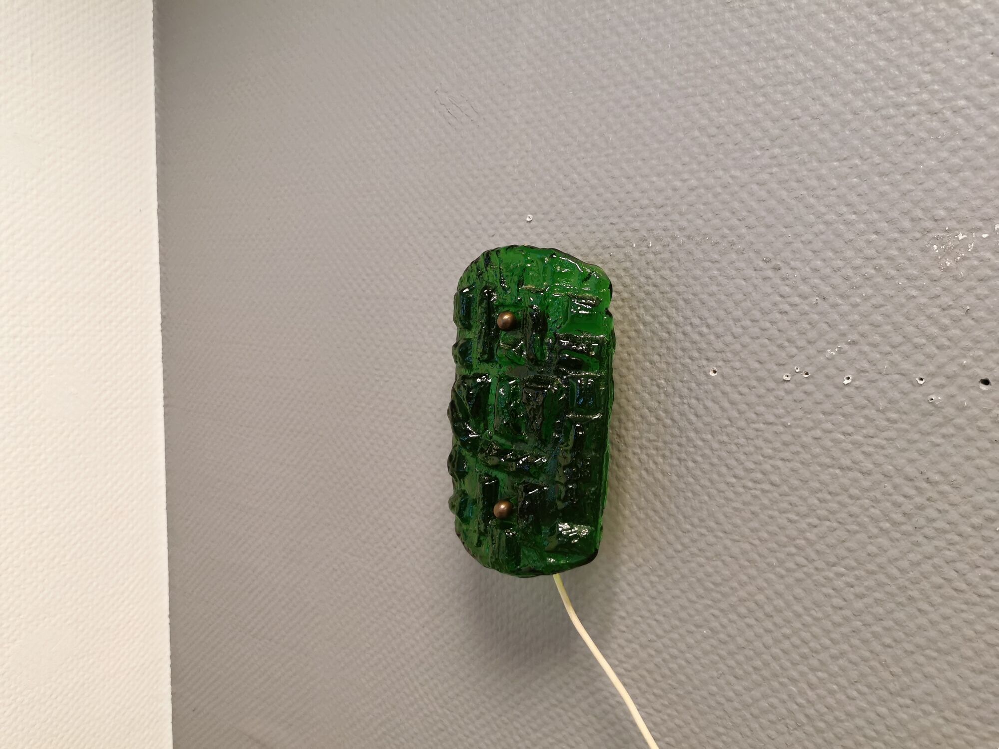 Old wall lamp made of hard pressed green glass.