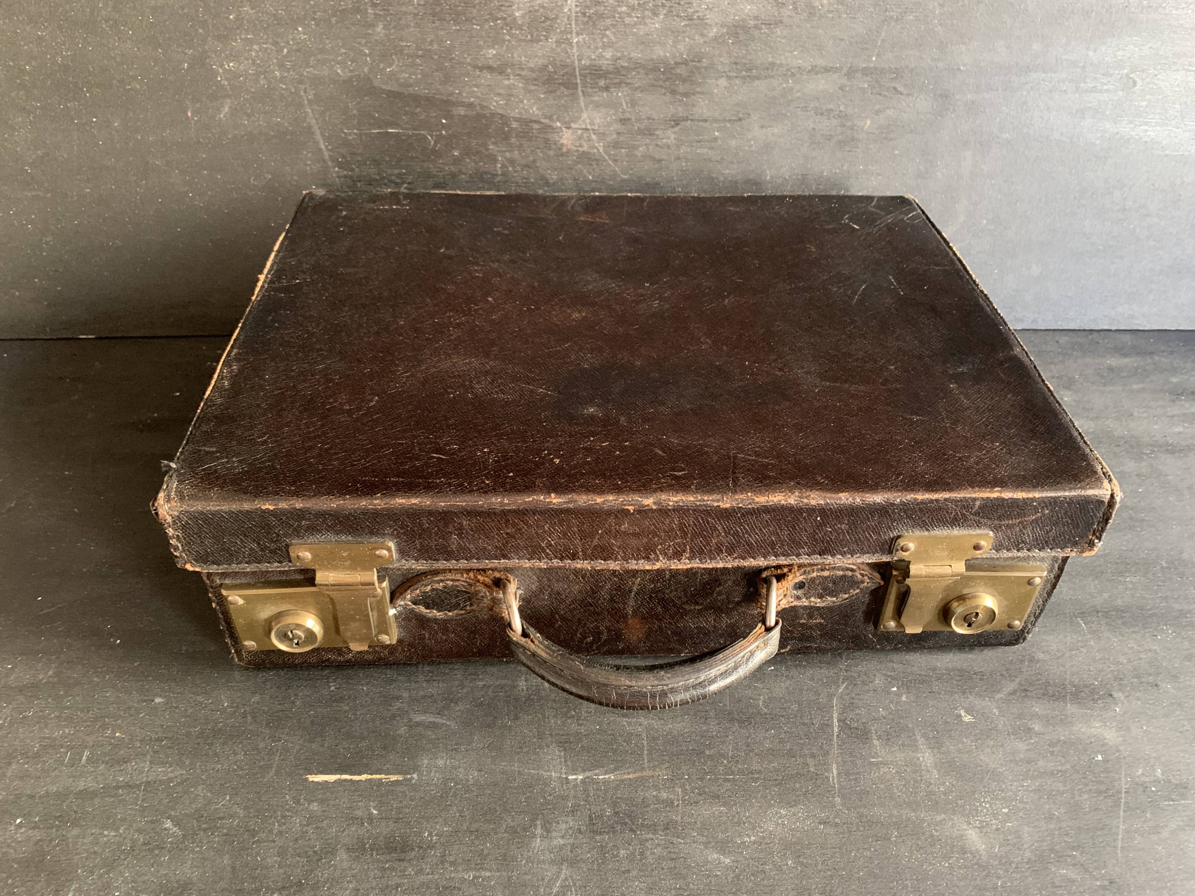 Small black grained leather travel suitcase from the 1920s