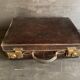 Small black grained leather travel suitcase from the 1920s
