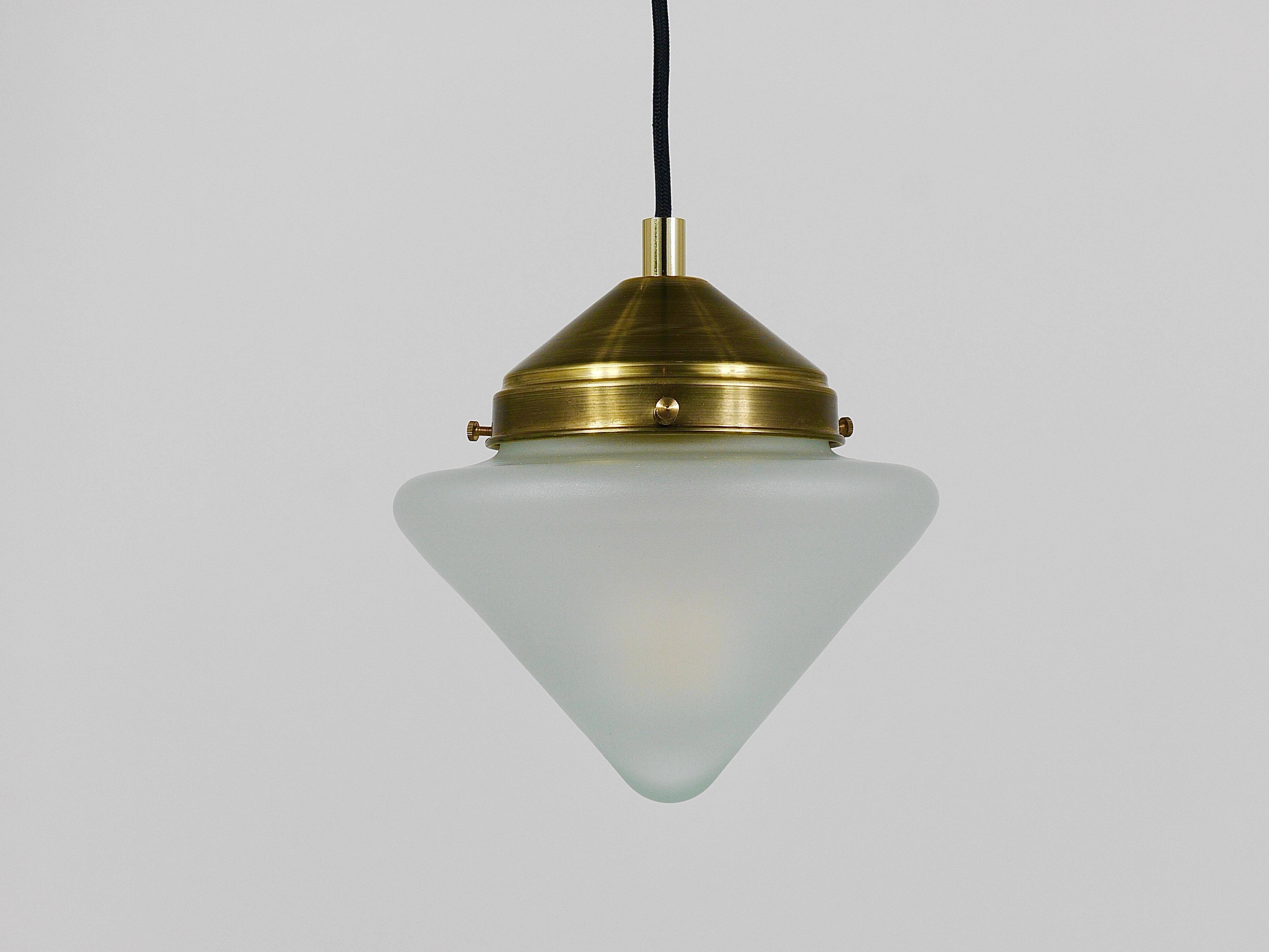 Up to 7 Art Deco brass pendant lights with conical glass shades, Vienna 1930s.