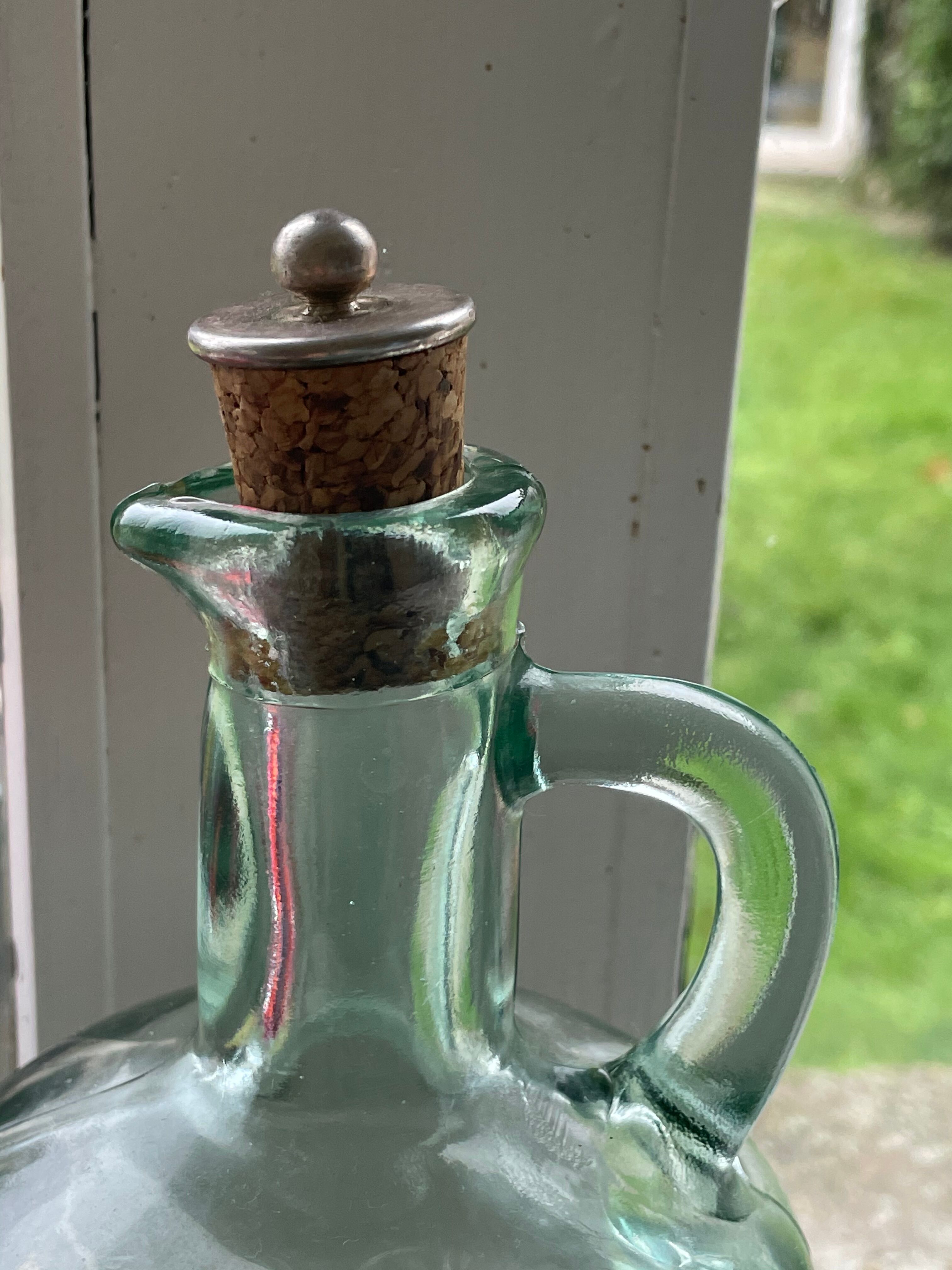 Green pitcher made of vintage glass