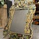 Eglomise glass mirror with scrollwork and branch races decoration