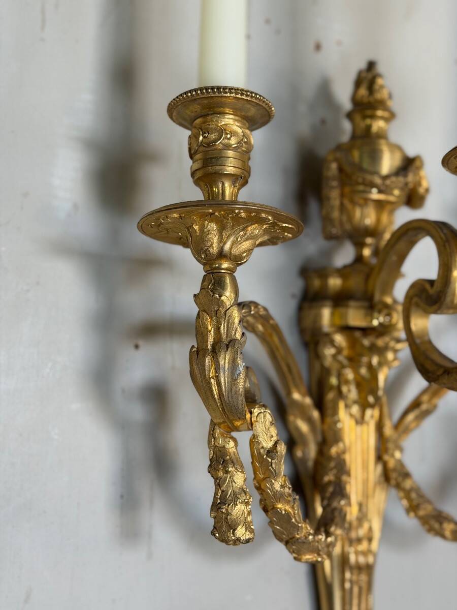 Pair of Louis XVI style wall sconces in gilded bronze, circa 1880.
