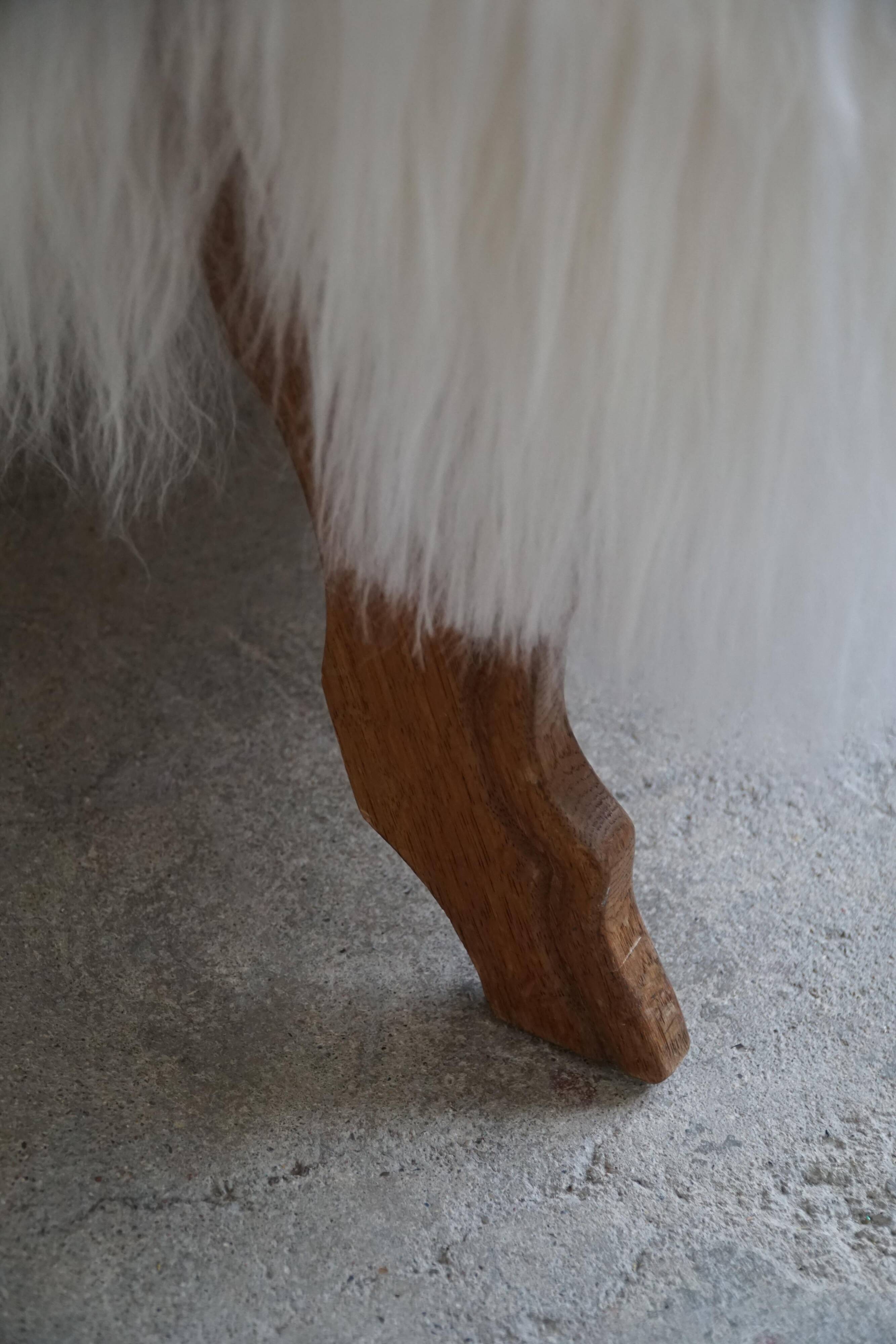Pair of Scandinavian armchairs in oak and long-haired Icelandic sheepskin by Henning Kjærnulf, 1950.