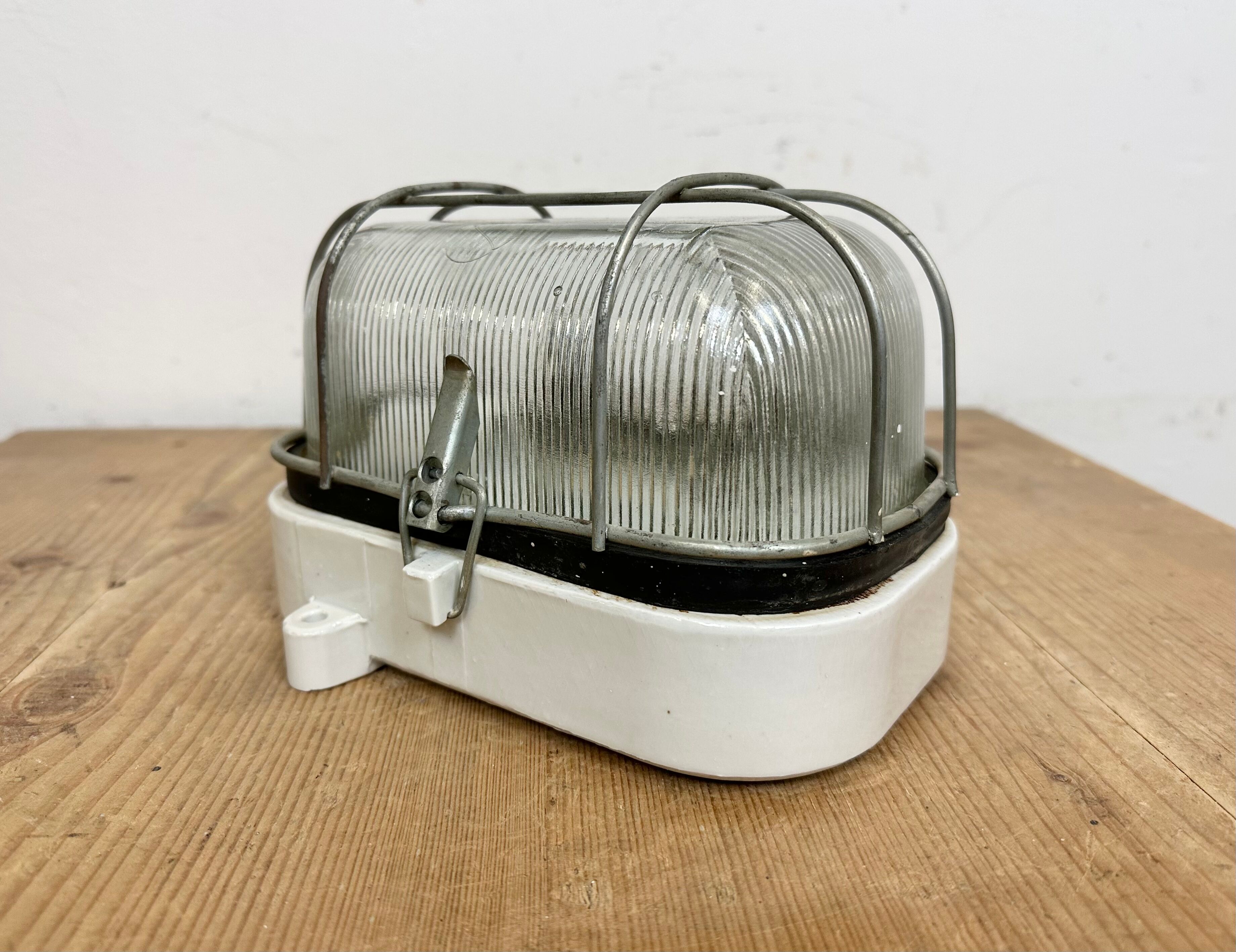 Industrial white porcelain cage wall light with ribbed glass, 1970s