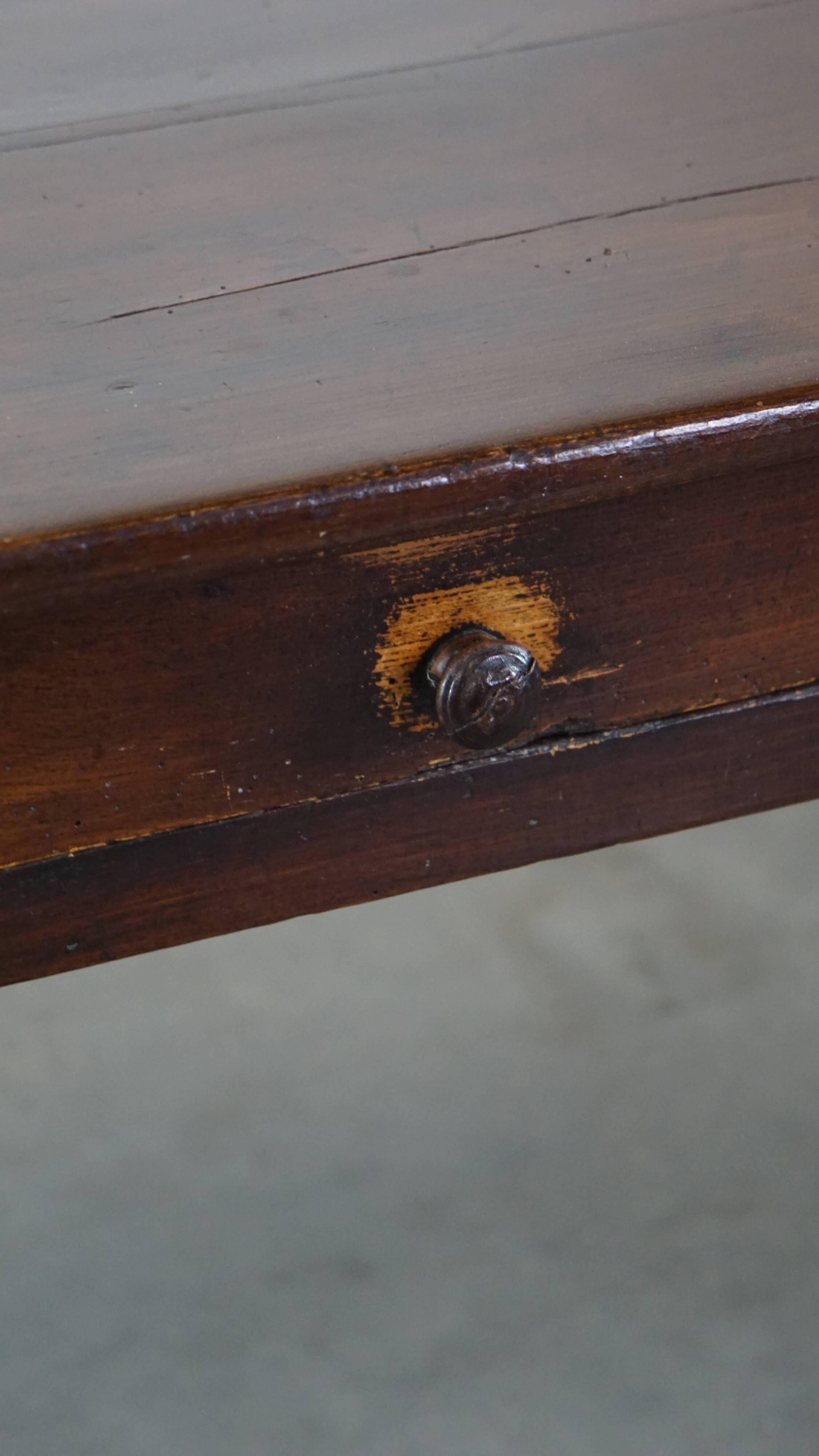 Antique French fruitwood dining table with 2 drawers and patina