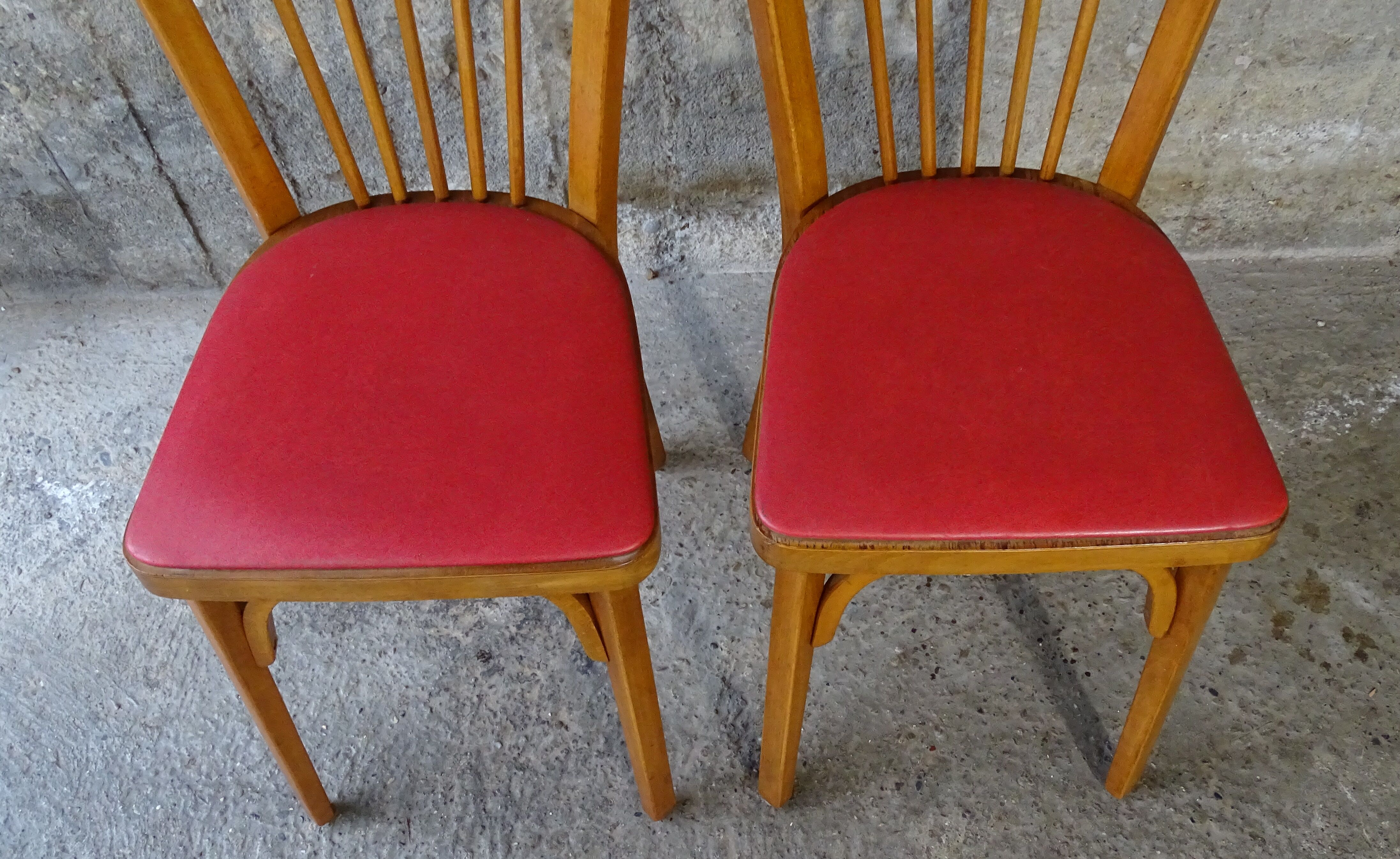 Pair of red Baumann skai chairs 1960