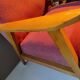 Vintage red armchair with compass feet in Scandinavian design