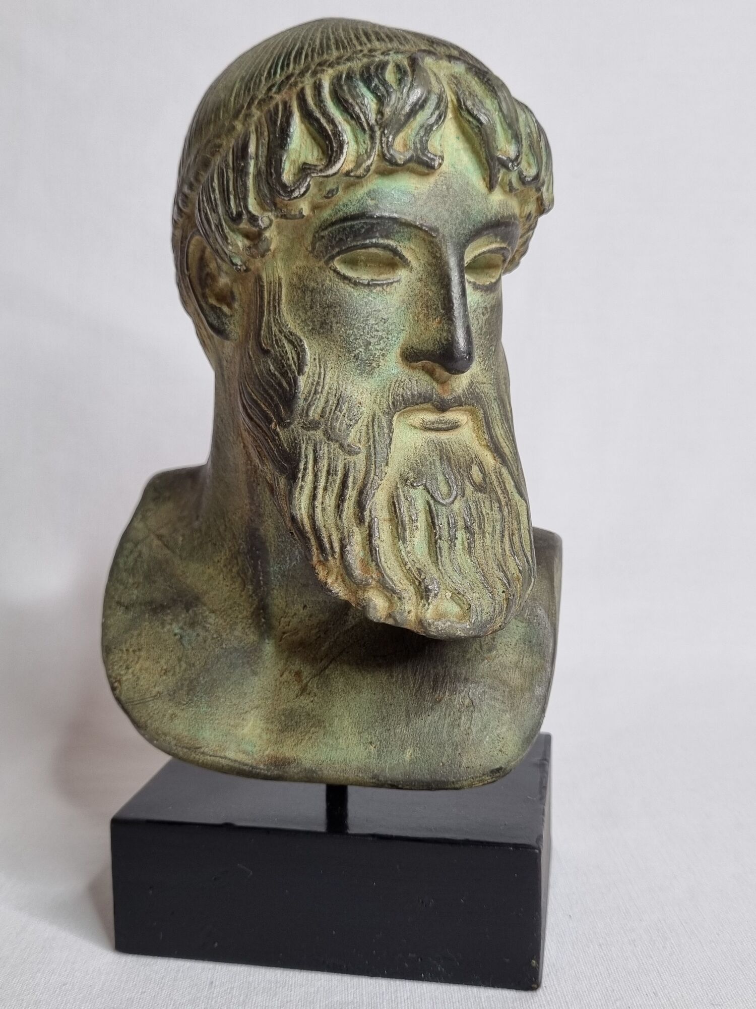 Bust of Poseidon in patinated plaster on wooden base