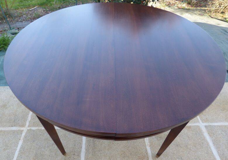 Round mahogany table with mahogany veneer and brass sabot foot.