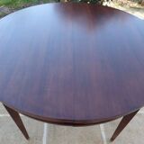 Round mahogany table with mahogany veneer and brass sabot foot.