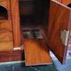 Rare four-column secretary from the Empire period in flame mahogany and bronze.