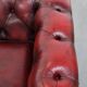Red English cowhide Chesterfield armchair finished with decorative nails