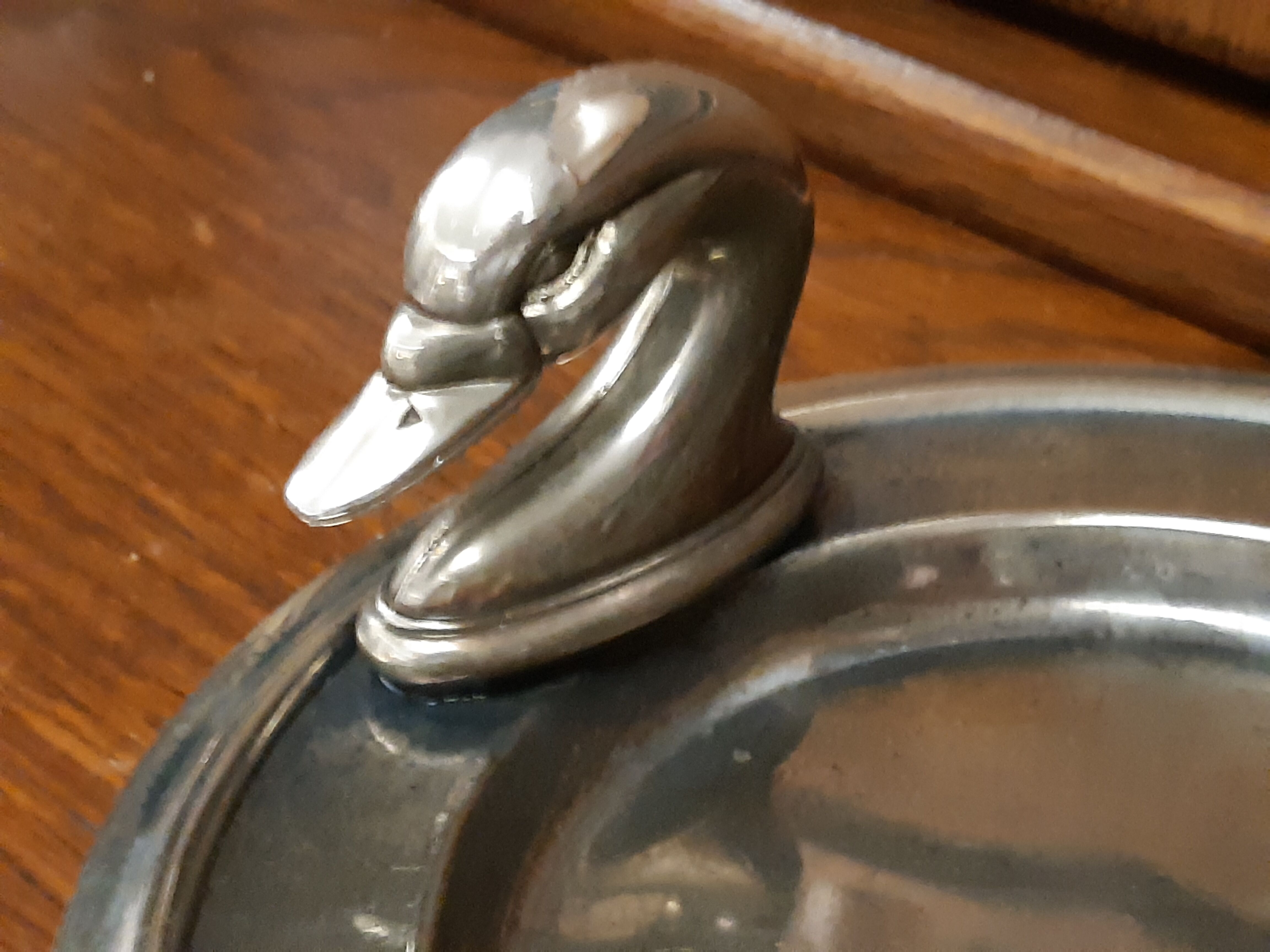 Silver dish with foie gras, duck heads