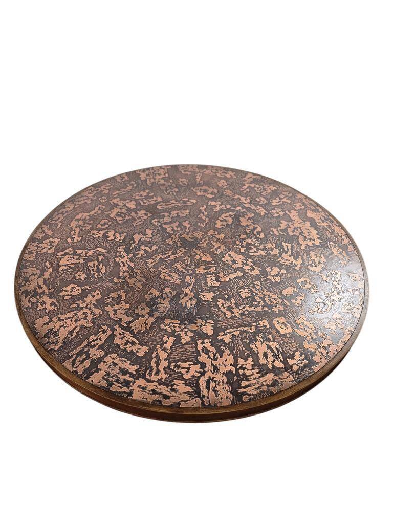 Vintage round wooden coffee table with a copper top.