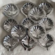 Set of 12 stainless steel scallop shells, 1970s-80s.