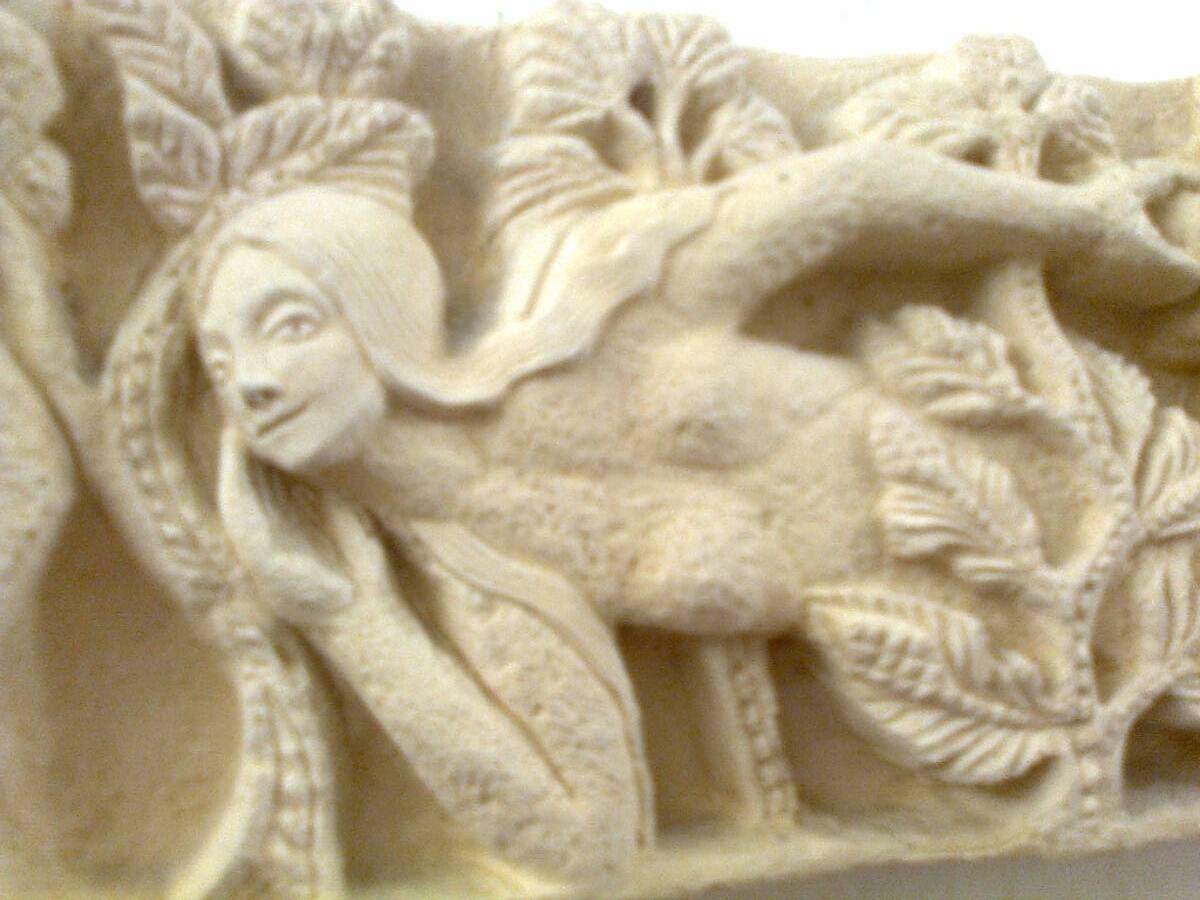 Sculpted stone wall decoration, medieval motif: Eve in the Garden of Eden