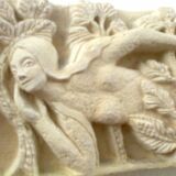 Sculpted stone wall decoration, medieval motif: Eve in the Garden of Eden