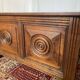 Small antique oak chest with carved panels.
