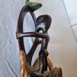 A large Senufo mask made of colored wood, decorated with an anthropomorphic figure