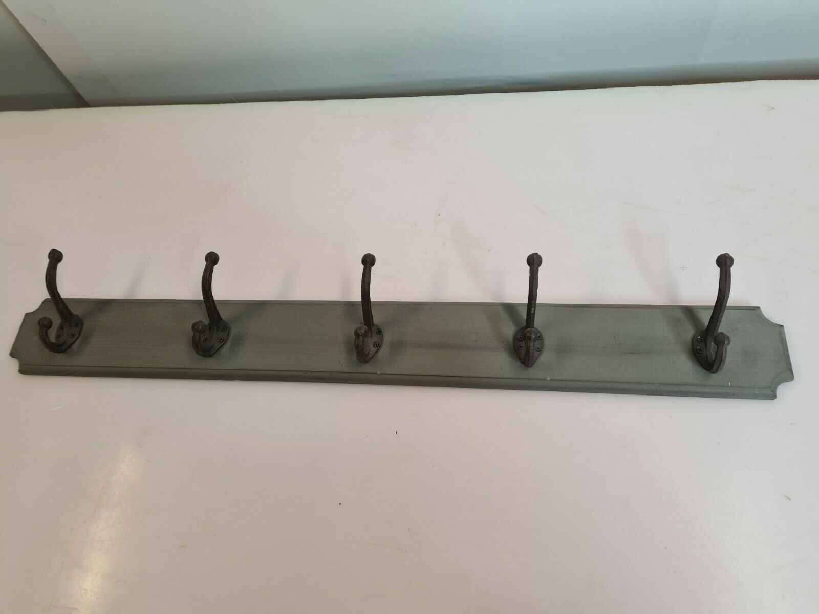 Wooden coat rack with cast iron hooks