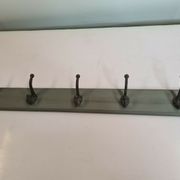 Wooden coat rack with cast iron hooks