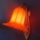 Art Deco wall light in brass with an orange globe.